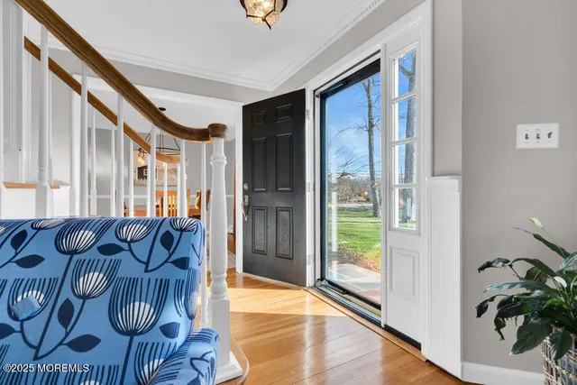 a view of entryway livingroom and hall with wooden floor