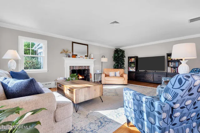 a living room with furniture a window and a fireplace