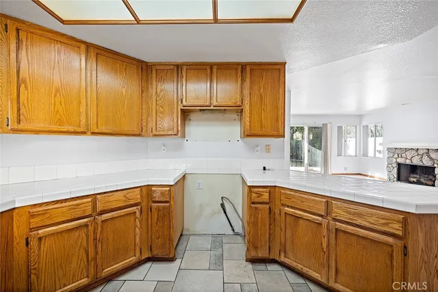 a kitchen with cabinets and outdoor view