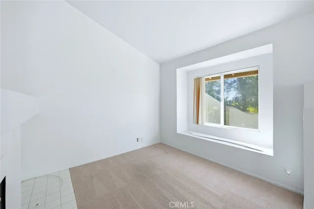 a view of a livingroom with an empty space and a fireplace
