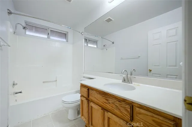 a spacious bathroom with a tub sink shower and mirror