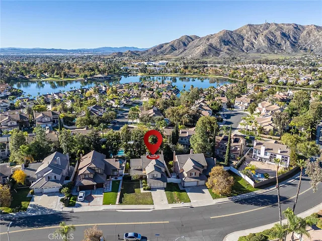 an aerial view of residential houses with outdoor space and ocean view