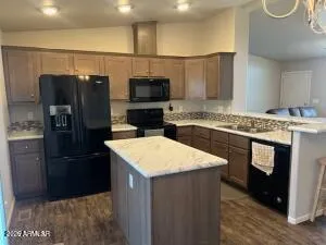 a kitchen with a sink stove and refrigerator