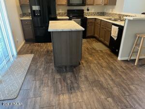 61 North 8620th Show Low, AZ 85901 - Photo 13 of 18 a kitchen with a sink stove and refrigerator
