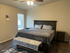 61 North 8620th Show Low, AZ 85901 - Photo 15 of 18 a bedroom with a bed and a chandelier