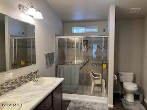 61 North 8620th Show Low, AZ 85901 - Photo 16 of 18 a bathroom with a granite countertop sink toilet and shower
