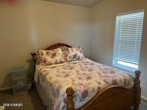 61 North 8620th Show Low, AZ 85901 - Photo 17 of 18 a bed sitting in a bedroom next to a window