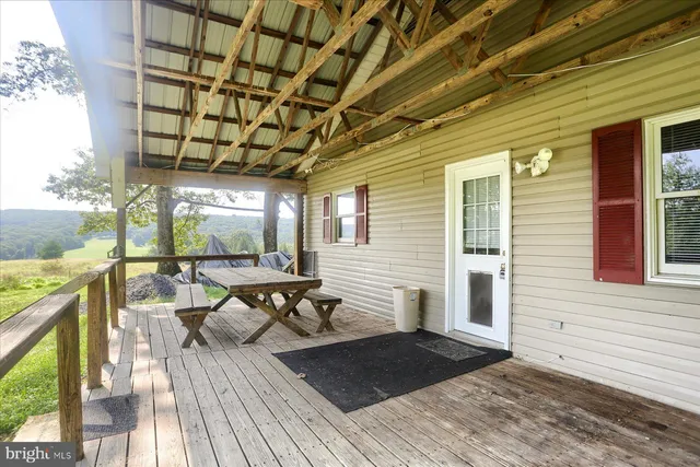a view of backyard with deck and outdoor seating