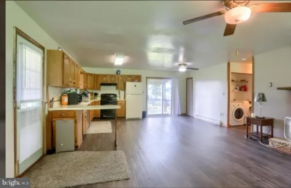 a view of a kitchen with furniture and a wooden floor