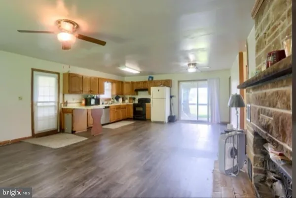 a kitchen with a refrigerator and a stove top oven