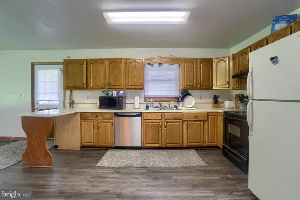 a kitchen with a refrigerator a stove a microwave and cabinets
