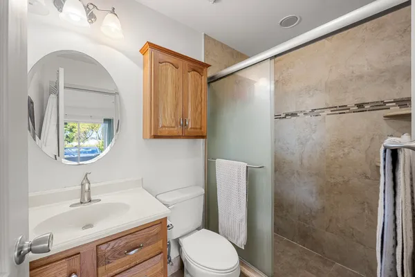 a bathroom with a sink toilet and shower