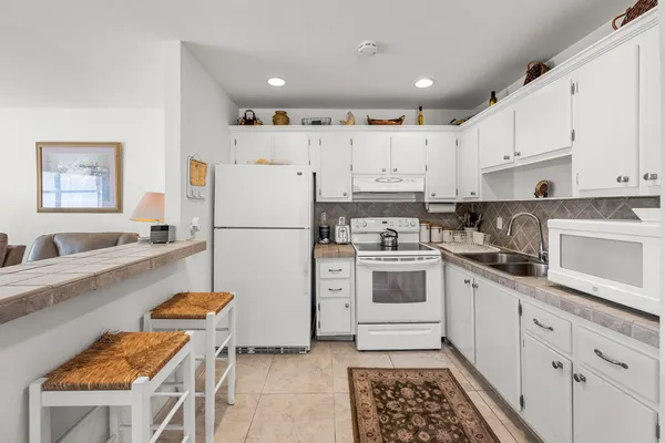 a kitchen with cabinets and white appliances