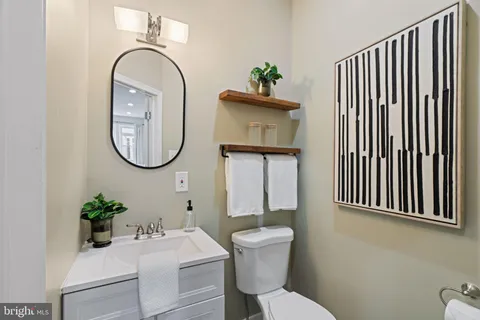 a bathroom with a toilet a sink and a mirror