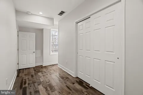 a view of hallway with wooden floor