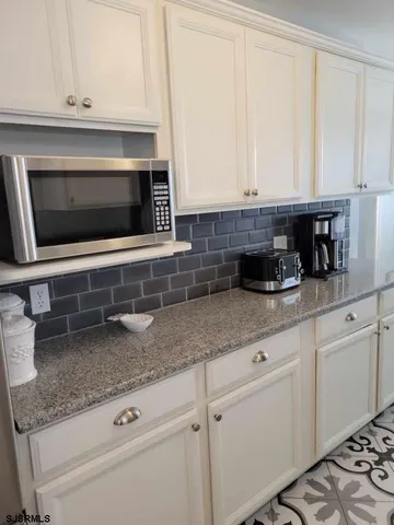 a view of a hallway with wooden floor and entryway