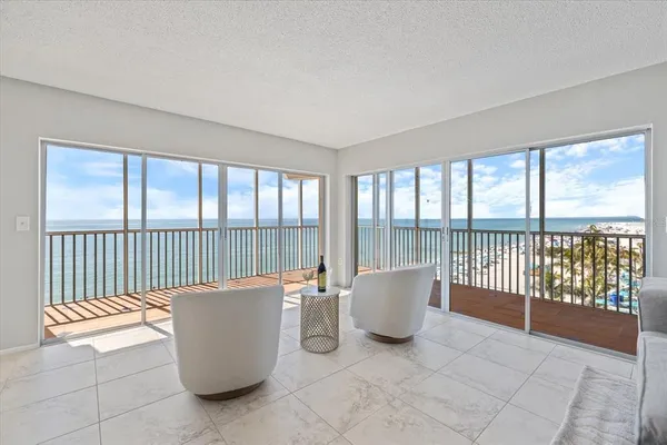 a view of a dining room and livingroom with furniture wooden floor and a rug