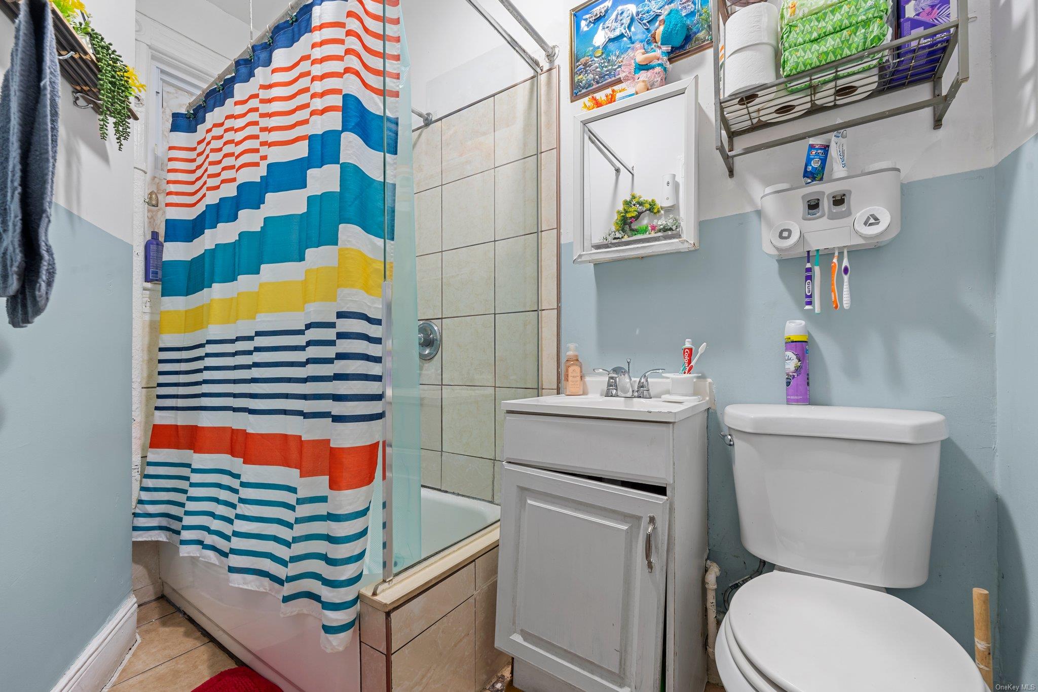 35-18 108th Street Queens, NY 11368 - Photo 18 of 20 Full bathroom featuring toilet, vanity, shower / bath combo, and tile patterned flooring