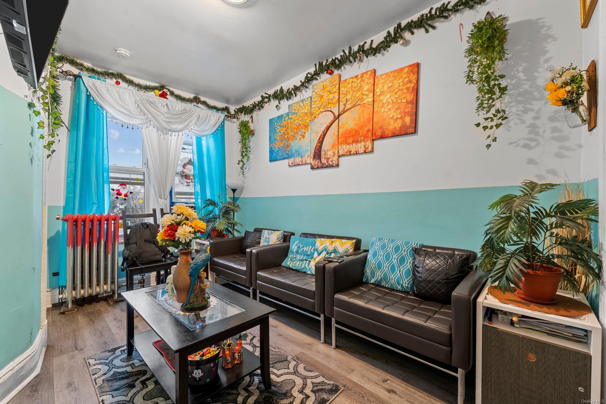 35-18 108th Street Queens, NY 11368 - Photo 9 of 20 Living room featuring radiator and hardwood / wood-style floors