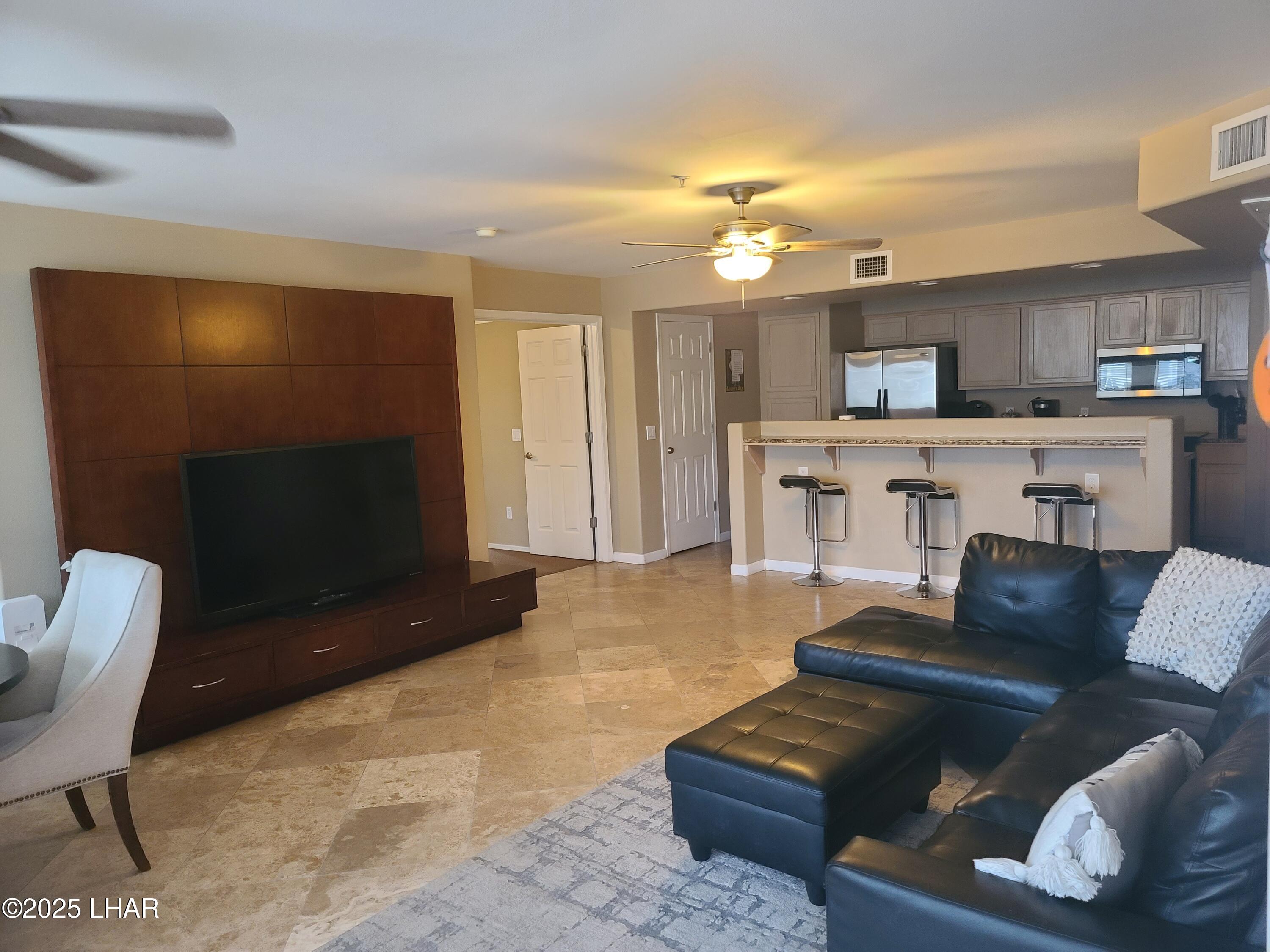 94 London Bridge Road, Unit 108 Lake Havasu City, AZ 86403 - Photo 14 of 38 a living room with furniture and a flat screen tv