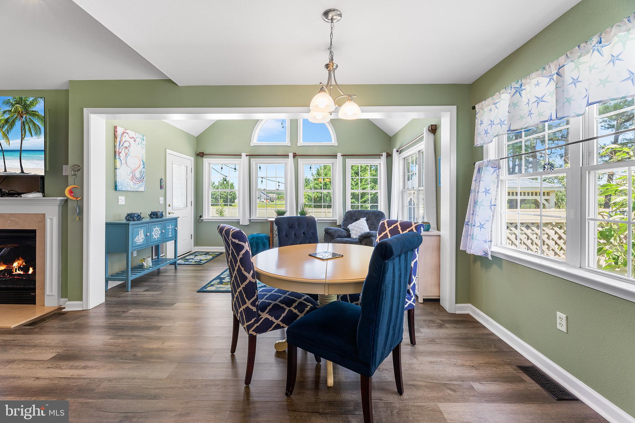 30249 Armory Road Dagsboro, DE 19939 - Photo 11 of 41 a dining room with furniture a chandelier and wooden floor