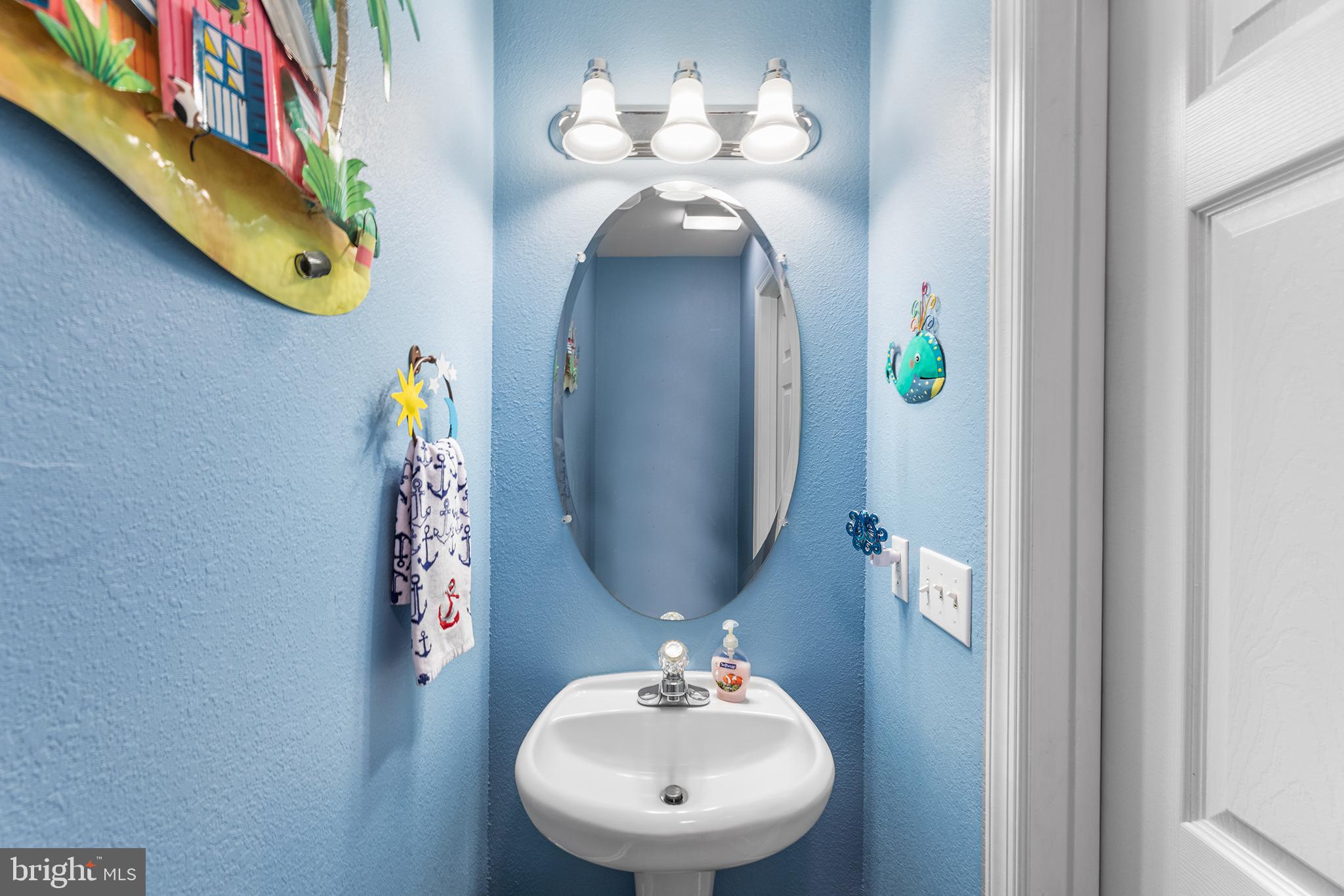 30249 Armory Road Dagsboro, DE 19939 - Photo 20 of 41 a bathroom with a sink and a mirror