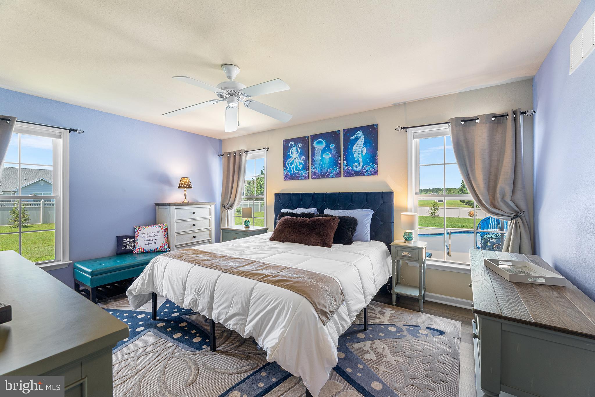 30249 Armory Road Dagsboro, DE 19939 - Photo 21 of 41 a bedroom with a bed and a chandelier