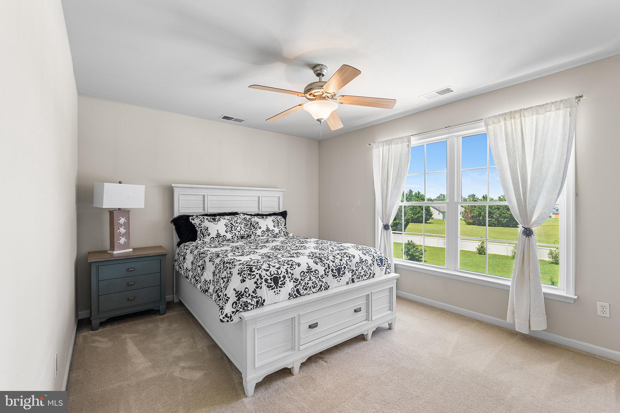 30249 Armory Road Dagsboro, DE 19939 - Photo 29 of 41 a bed sitting in a bedroom next to a window