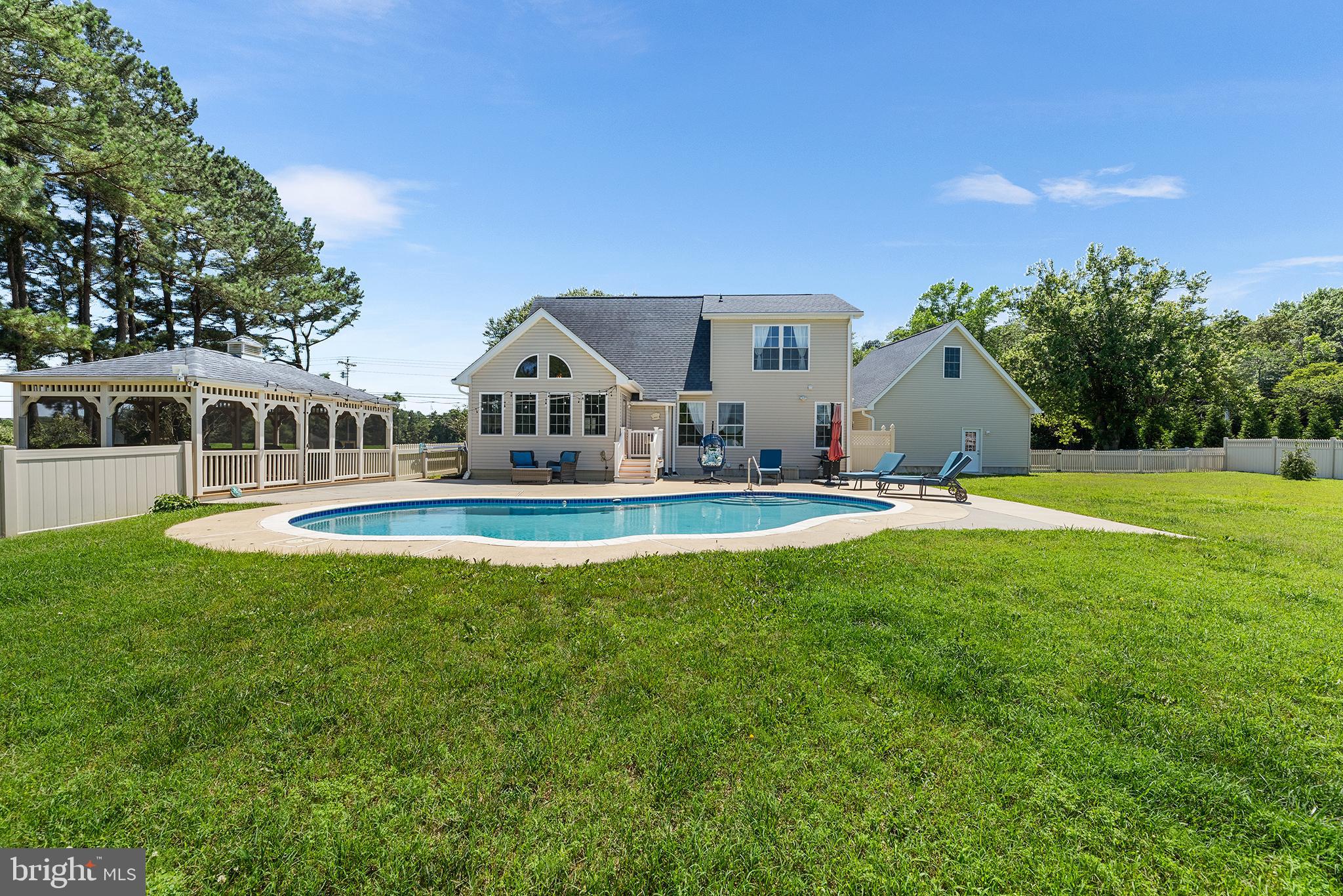 30249 Armory Road Dagsboro, DE 19939 - Photo 35 of 41 a view of swimming pool with lawn chairs and large trees
