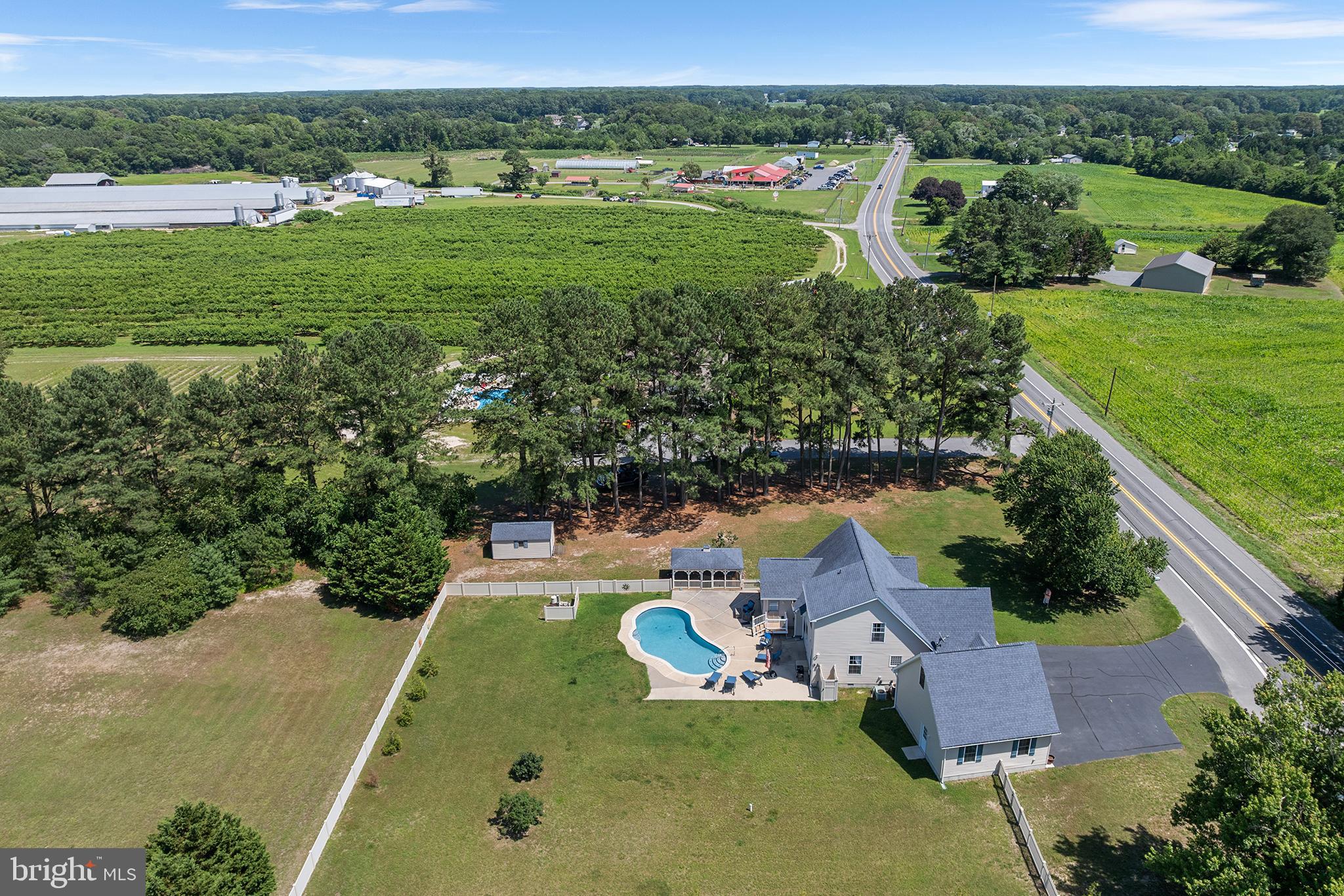 30249 Armory Road Dagsboro, DE 19939 - Photo 40 of 41 an aerial view of a house with a garden and lake view