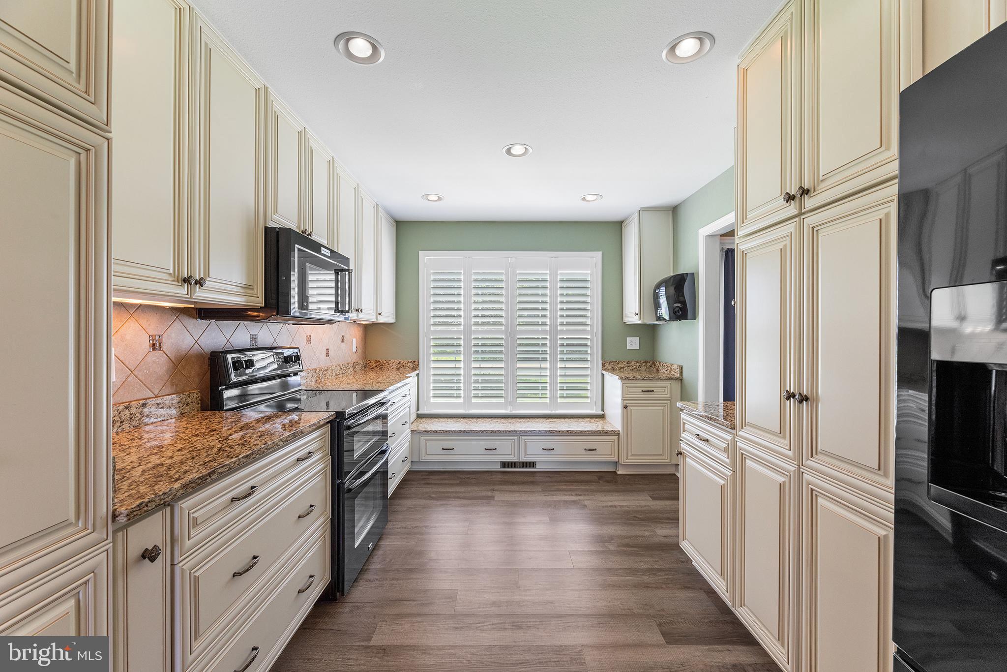 30249 Armory Road Dagsboro, DE 19939 - Photo 8 of 41 a kitchen with granite countertop white cabinets and white appliances