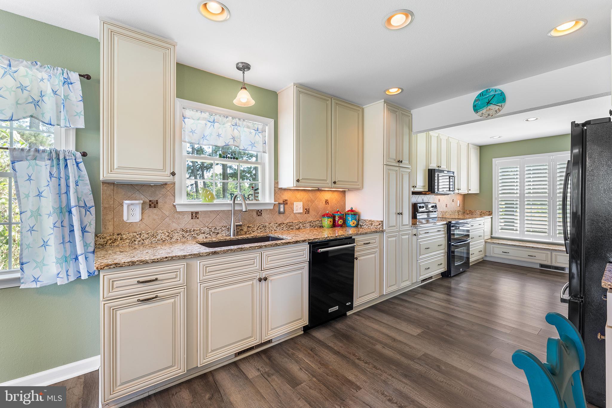 30249 Armory Road Dagsboro, DE 19939 - Photo 9 of 41 a kitchen with stove cabinets and wooden floor