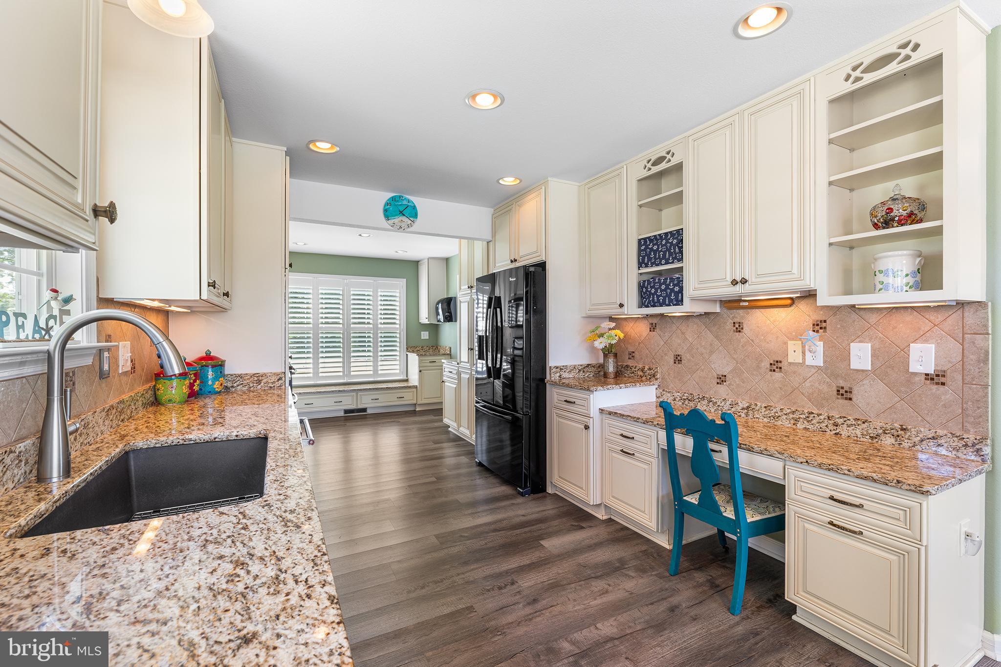 30249 Armory Road Dagsboro, DE 19939 - Photo 10 of 41 a kitchen with stainless steel appliances granite countertop a stove top oven a sink dishwasher and cabinets with wooden floor