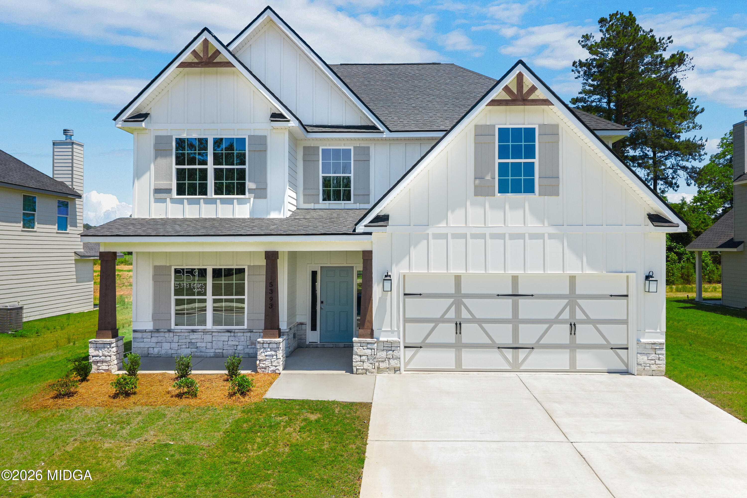 5393 Felles Way, Unit 359 Forsyth, GA 31029 - Photo 1 of 54 a view of a white house with a yard potted plants and large tree