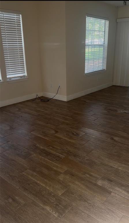 1017 South Hiawassee Road, Unit 3712 Orlando, FL 32835 - Photo 11 of 18 an empty room with wooden floor and windows