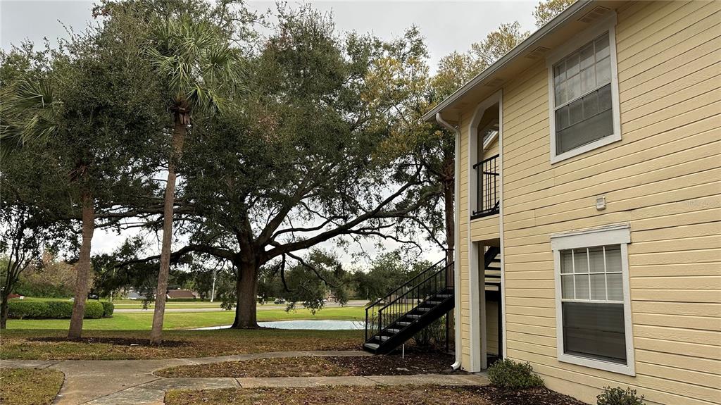 1017 South Hiawassee Road, Unit 3712 Orlando, FL 32835 - Photo 12 of 18 a front view of a house with a yard and tree s