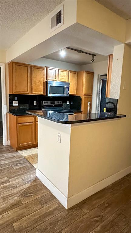 1017 South Hiawassee Road, Unit 3712 Orlando, FL 32835 - Photo 2 of 18 a kitchen with stainless steel appliances granite countertop a sink and a stove