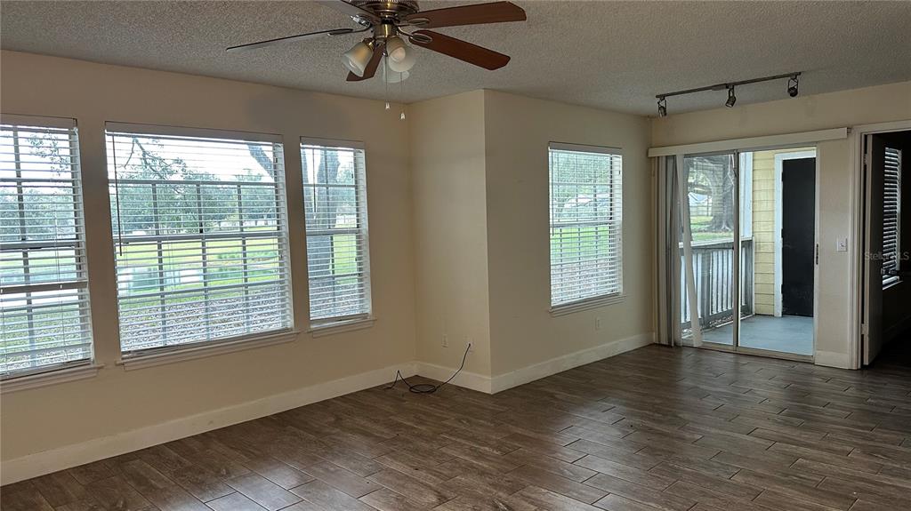 1017 South Hiawassee Road, Unit 3712 Orlando, FL 32835 - Photo 4 of 18 a view of an empty room with wooden floor and a window