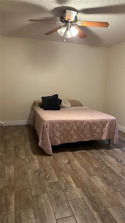 1017 South Hiawassee Road, Unit 3712 Orlando, FL 32835 - Photo 8 of 18 a bedroom with a bed and a ceiling fan