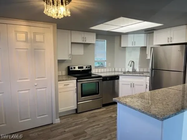 a kitchen with a sink dishwasher a refrigerator and a stove