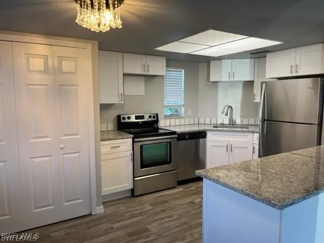 a kitchen with a sink dishwasher a refrigerator and a stove