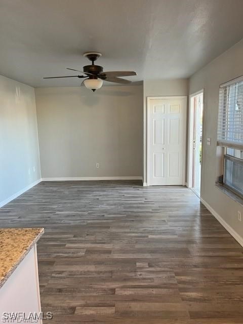 5019 Southwest 16th Place, Unit 101 Cape Coral, FL 33914 - Photo 3 of 7 wooden floor in an empty room with a window
