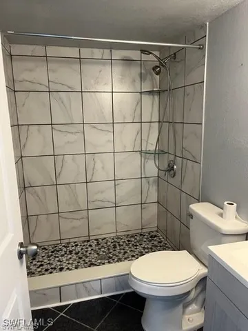 a bathroom with a toilet and a shower