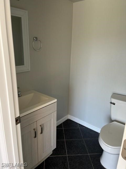 5019 Southwest 16th Place, Unit 101 Cape Coral, FL 33914 - Photo 7 of 7 a bathroom with a sink and toilet