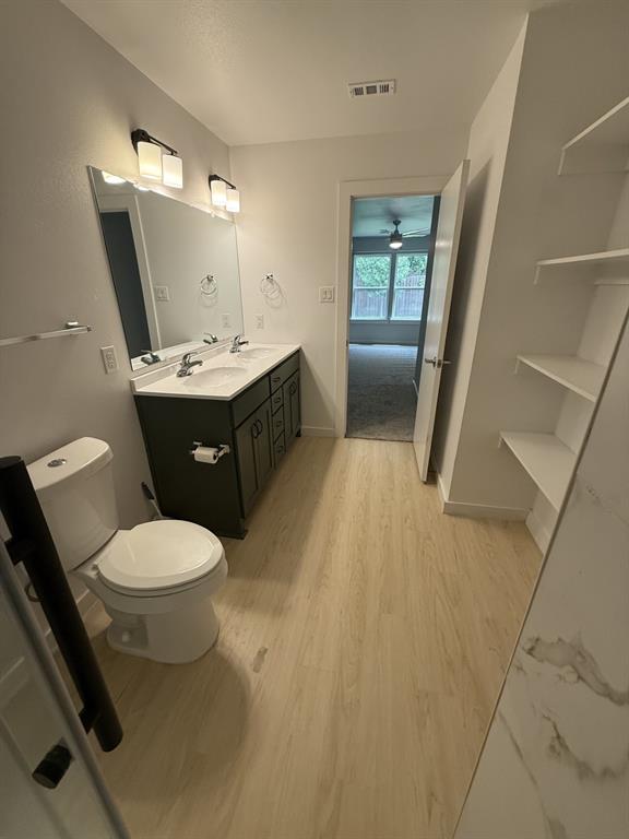505 Thomas Street Terrell, TX 75160 - Photo 24 of 38 Bathroom featuring a dual vanity with dark cabinetry, integrated sinks, and contemporary lighting