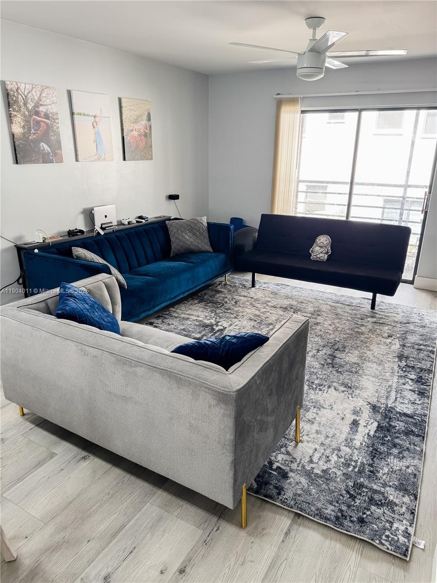 841 Northeast 207th Lane, Unit 3204 Miami, FL 33179 - Photo 1 of 37 a living room with furniture and a large window