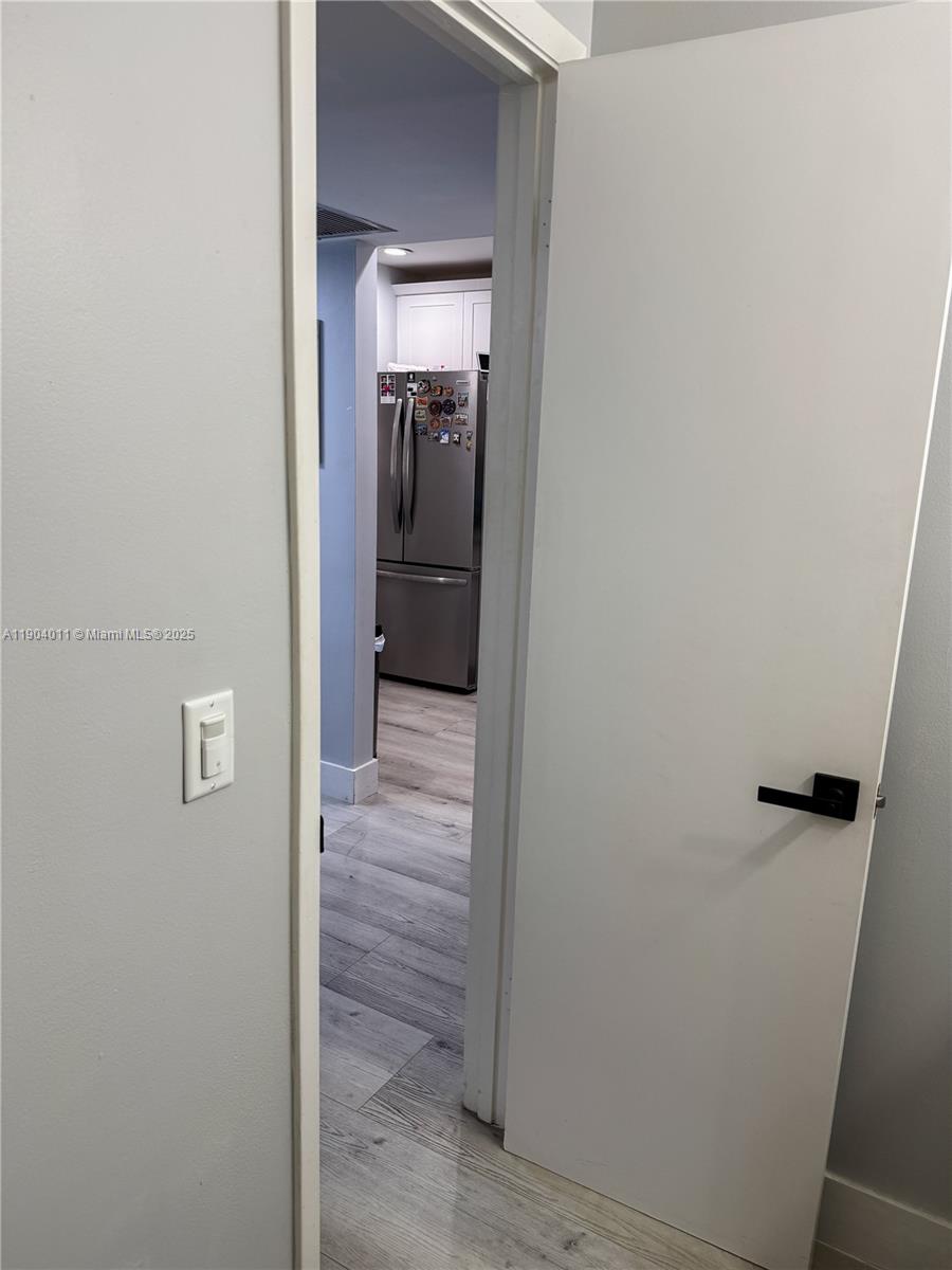 841 Northeast 207th Lane, Unit 3204 Miami, FL 33179 - Photo 17 of 37 a view of a hallway with wooden floor