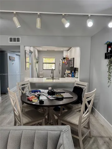 a living room with kitchen island furniture and a kitchen view