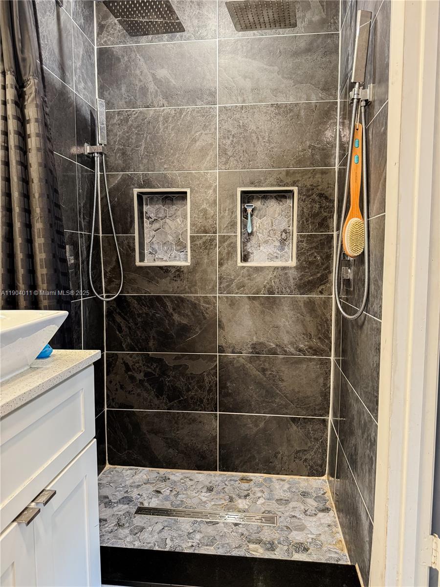 841 Northeast 207th Lane, Unit 3204 Miami, FL 33179 - Photo 2 of 37 a bathroom with a shower