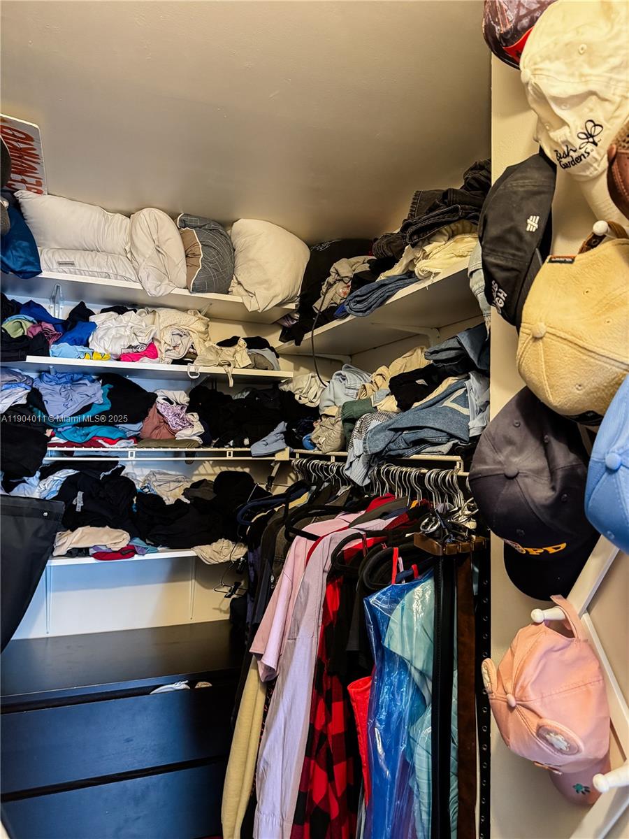 841 Northeast 207th Lane, Unit 3204 Miami, FL 33179 - Photo 31 of 37 a view of walk in closet with clothes and shoes